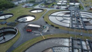 Aerial view of wastewater treatment plant with round pools for filtration of dirty water